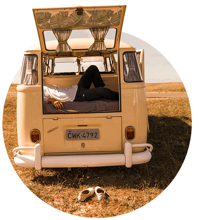 Person lying in the back of a camper van