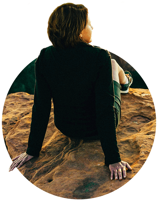 Woman sitting on a rock